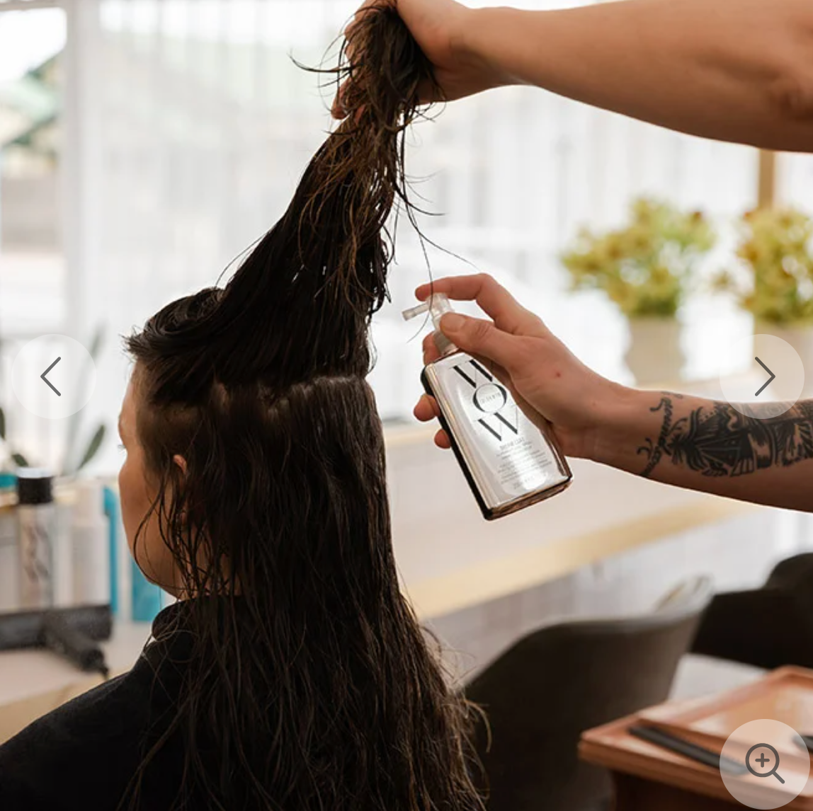 Color Wow Dream Coat Supernatural Hair Styling Spray being used on hair